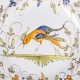 Le Grenier de la Mandoune. Assiette en faïence de Moutiers signée D.M., décor à l’oiseau
